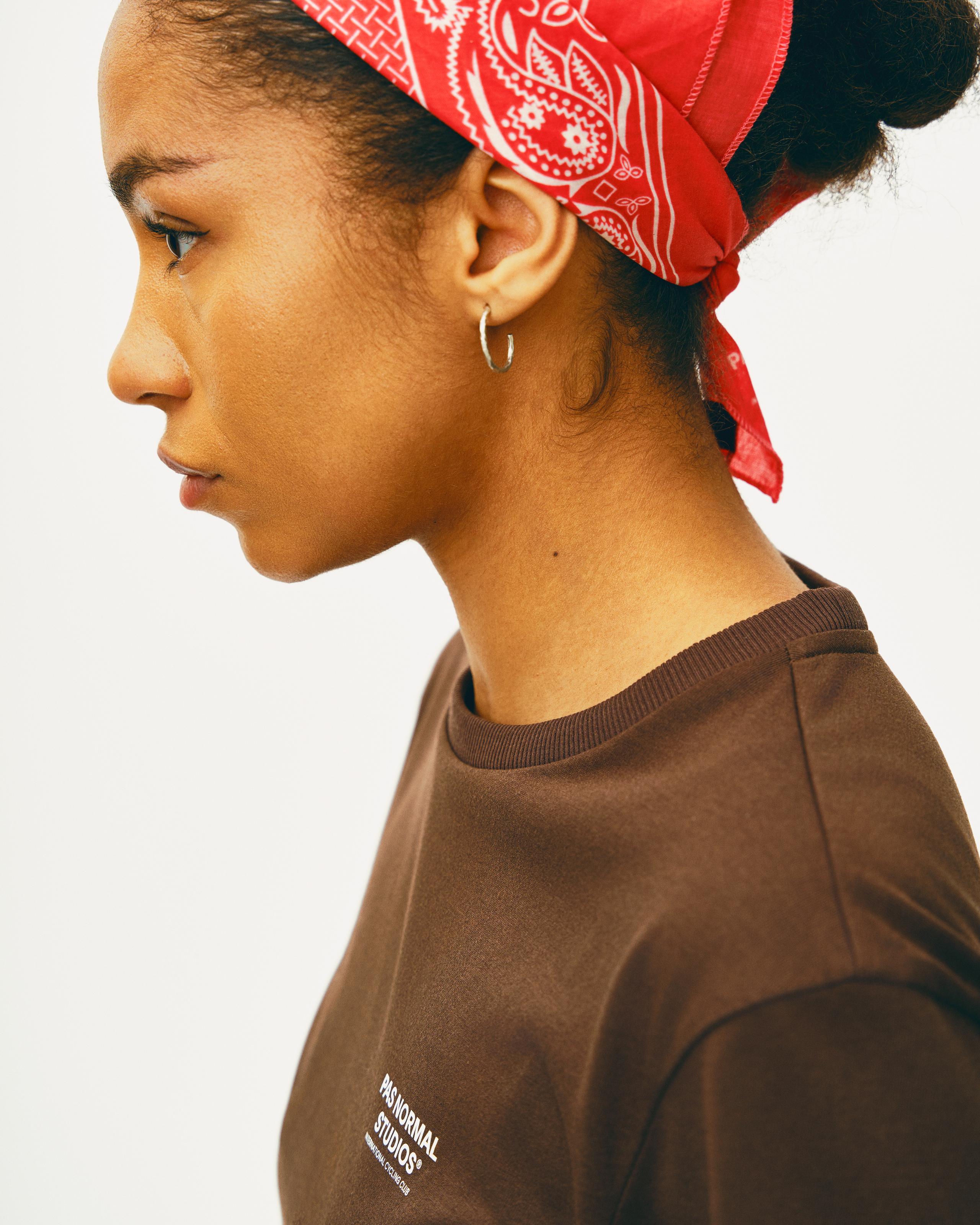 Red Off-Race bandana on model side view with white paisley pattern