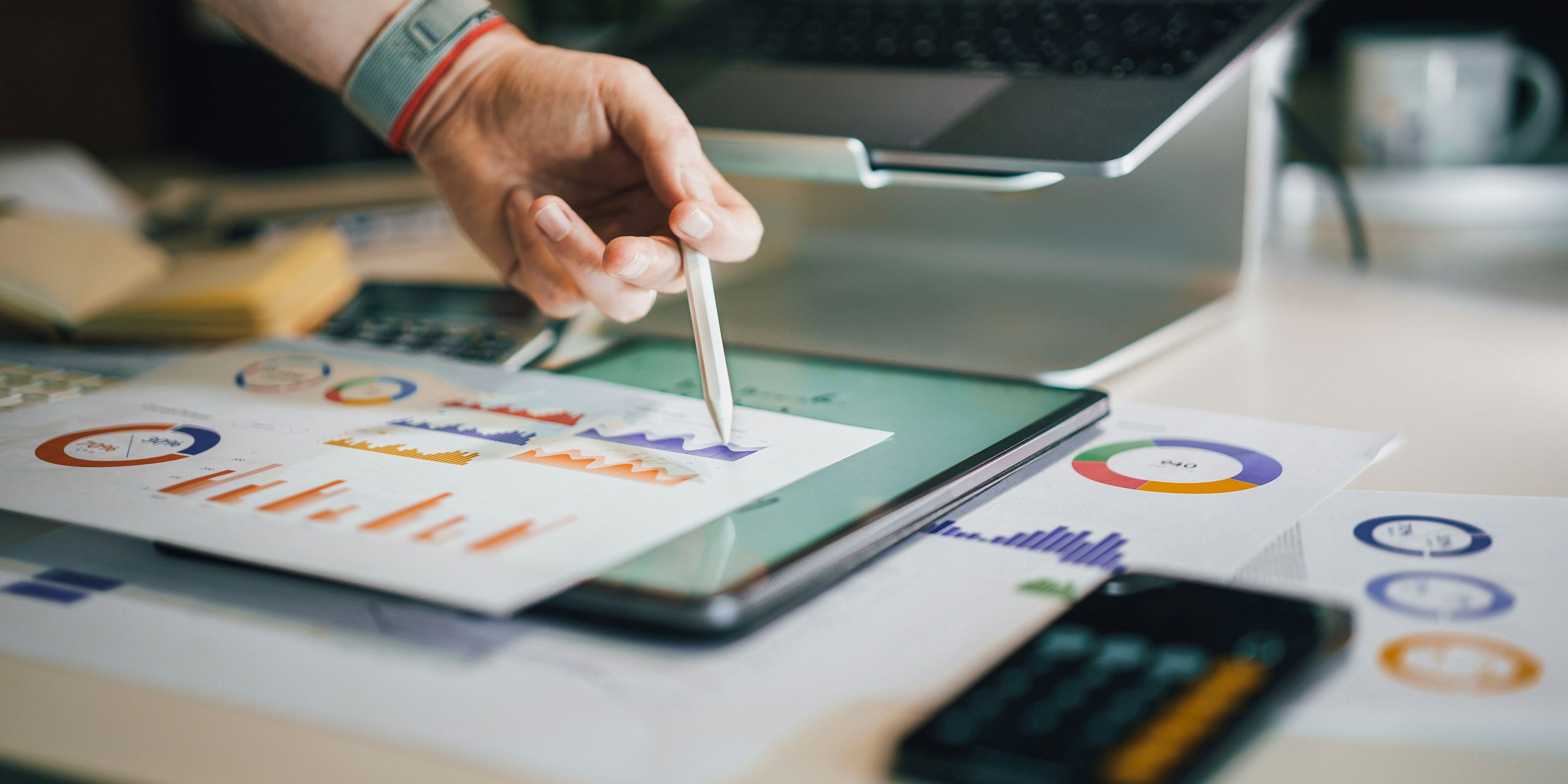 a person is drawing on a tablet with a pen .