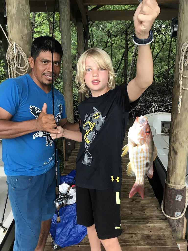 Young guest catching fish for dinner at Bocas lodge