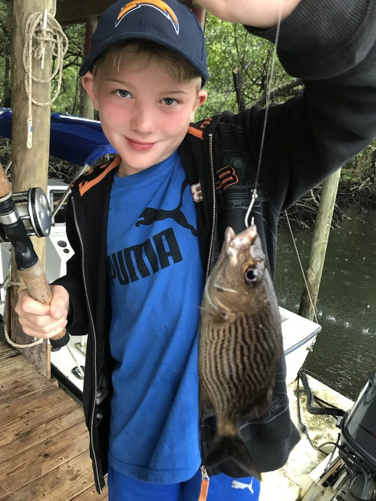 Another young guest catching fish off the dock