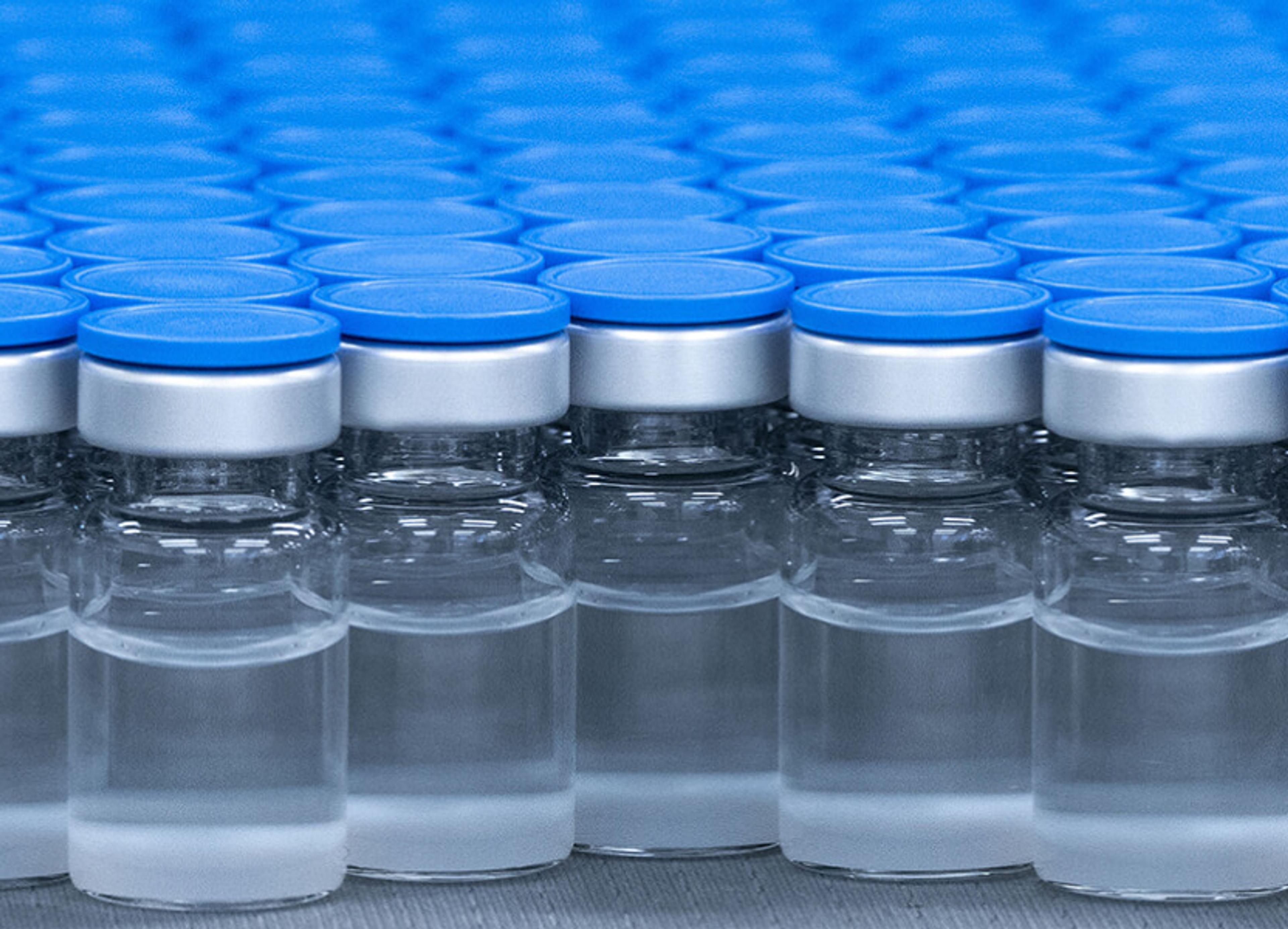  Group of glass vaccine vials with blue caps