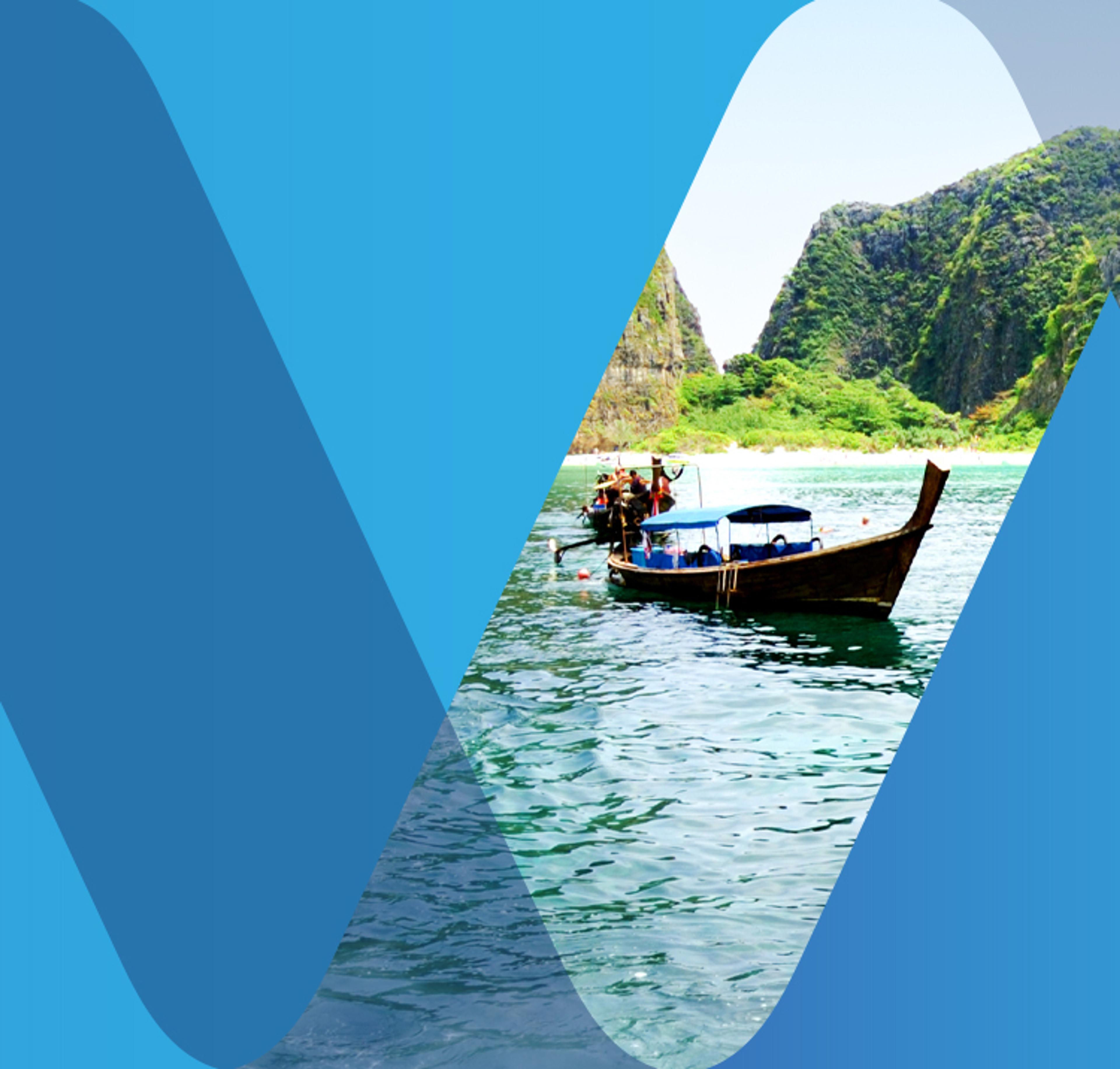 Long-tail boat with mountains behind in clear blue water