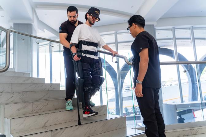 A patient uses ReWalk Personal Robotic Exoskeleton to navigate down stairs