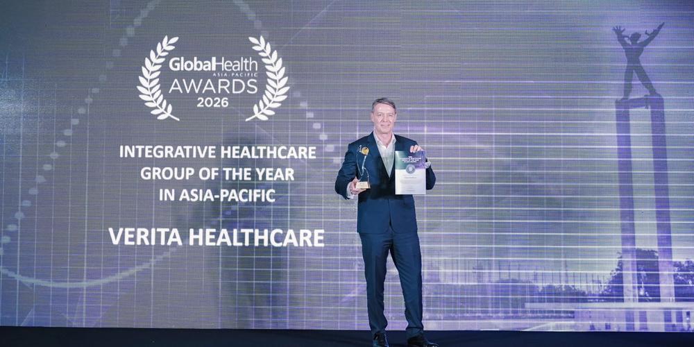 Julian Andriesz gets onto the stage to accept the Global Health Awards 2026 as Integrative Healthcare Group of the Year and Health Tech Innovator of the Year in Asia-Pacific.