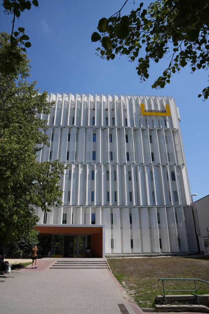 A picture of a tall white building with a tree in front of it. This is the Unbroken Rehabilitation Center building in Lviv, Ukraine