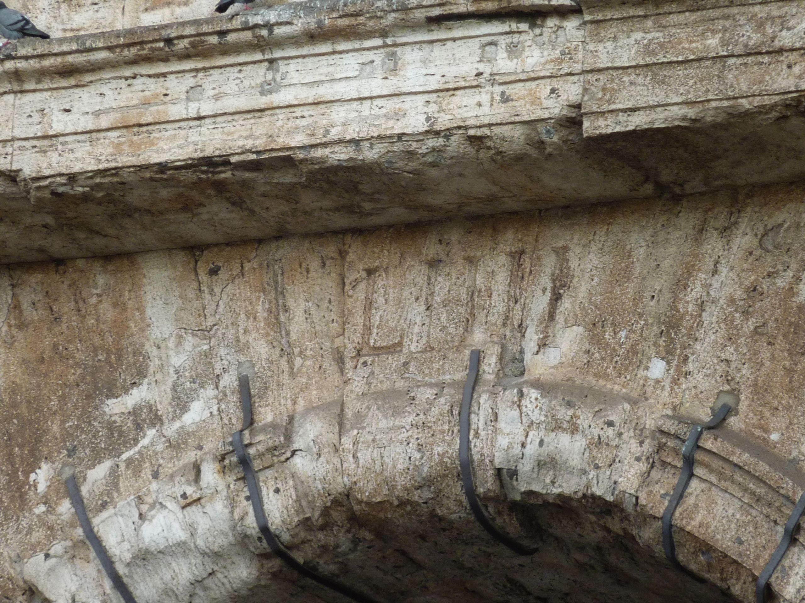 Entrance numbers carved in Roman numerals still seen on the Colosseum today.