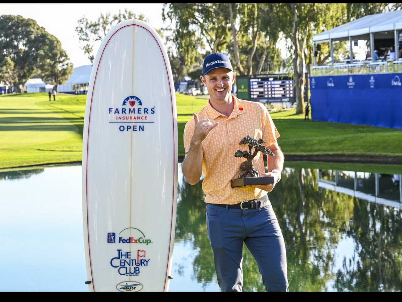 Justin Rose and surfboard and trophy at Farmers Insurance Golf