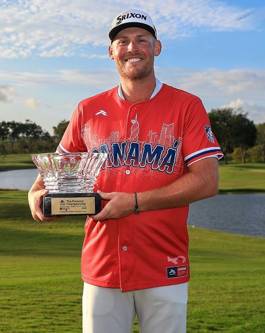 Ian Holt holding Panama Championship trophy