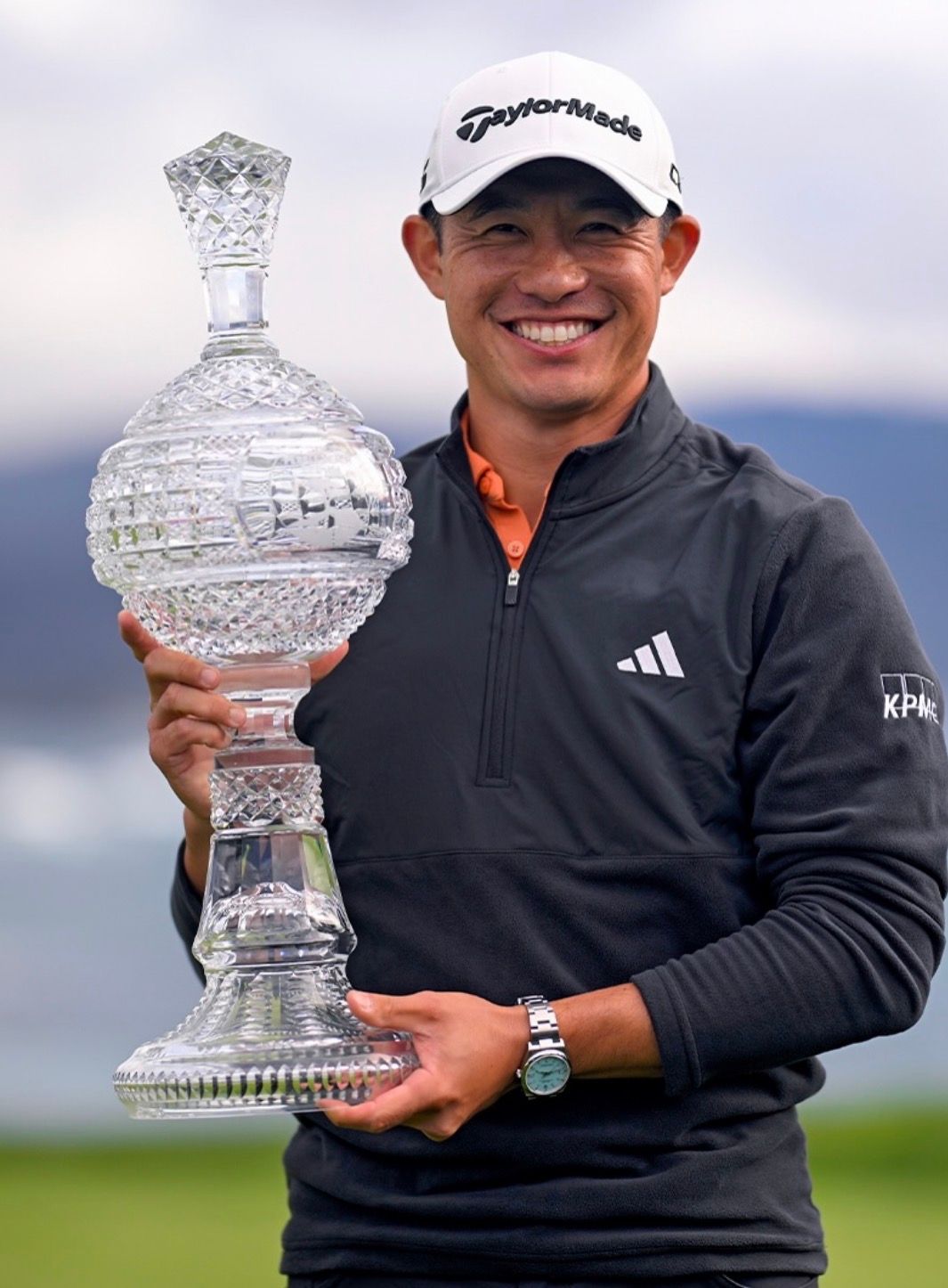Colin Morikawa holds his trophy