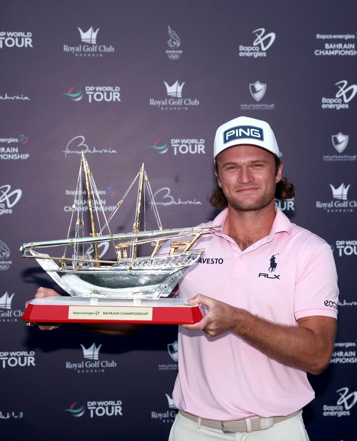Freddy Schott holding Bahrain championship trophy