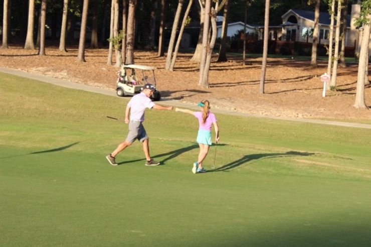 Op 36 coach and student out on the golf course