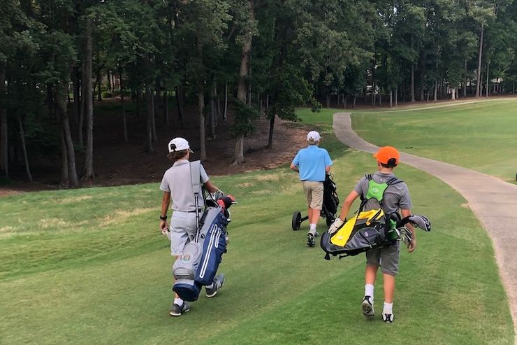 Junior golfers playing golf