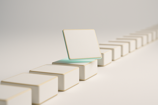 A row of identical white cards on a clean surface with one card lifted and highlighted, suggesting sequential processing.