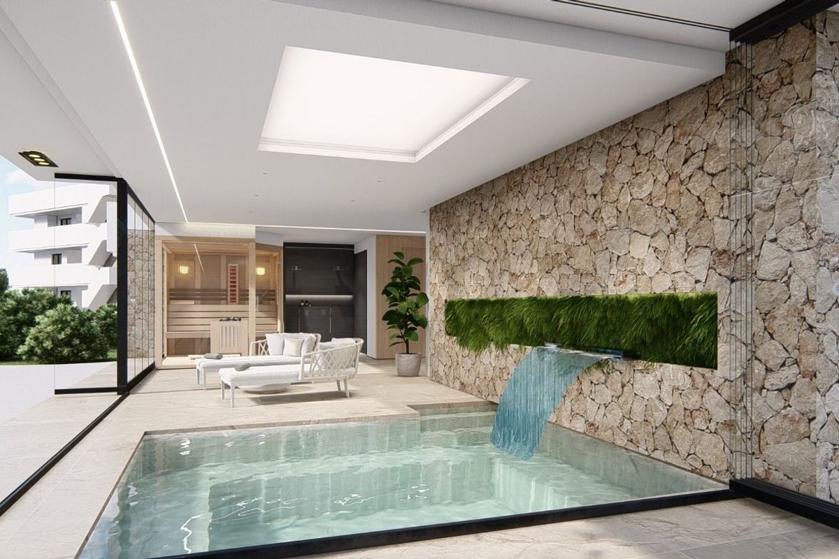 Indoor view showcasing a luxurious swimming pool area with a waterfall feature, within the apartment complex.