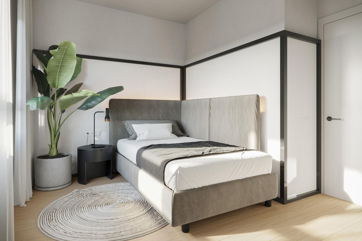 Gezellige eenpersoons slaapkamer in een moderne bungalow, met een grote plant en stijlvol ontwerp in San Miguel de Salinas.