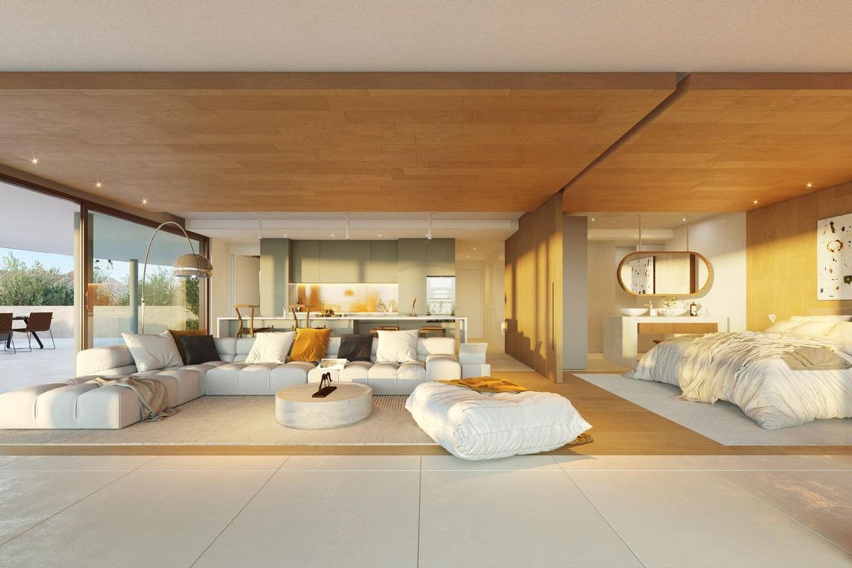 Eigentijdse slaapkamer en lounge, met grote ramen en toegang tot buiten in Fuengirola.