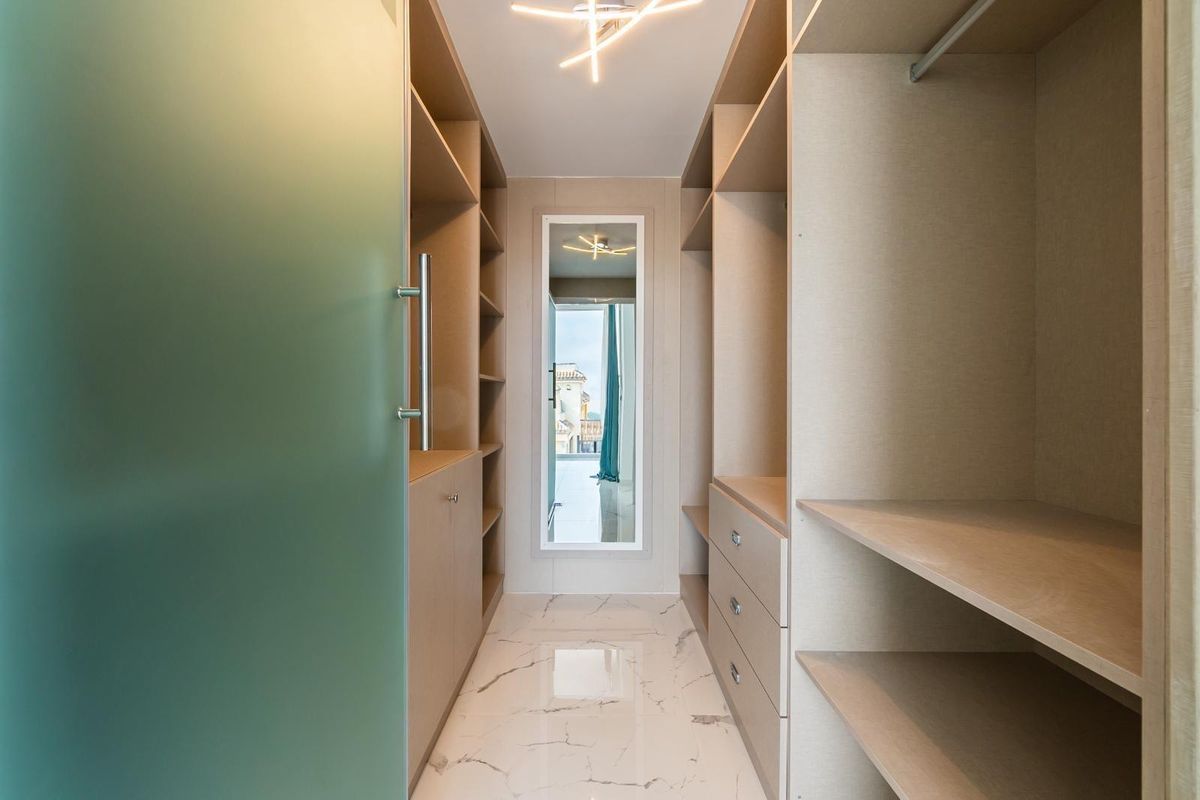 Spacious walk-in closet with ample storage and mirrors in Orihuela Costa villa.