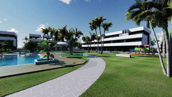 Sfeervol uitzicht op de buitenkant van het appartementencomplex in Guardamar del Segura, met groene tuinen en een zwembad.
