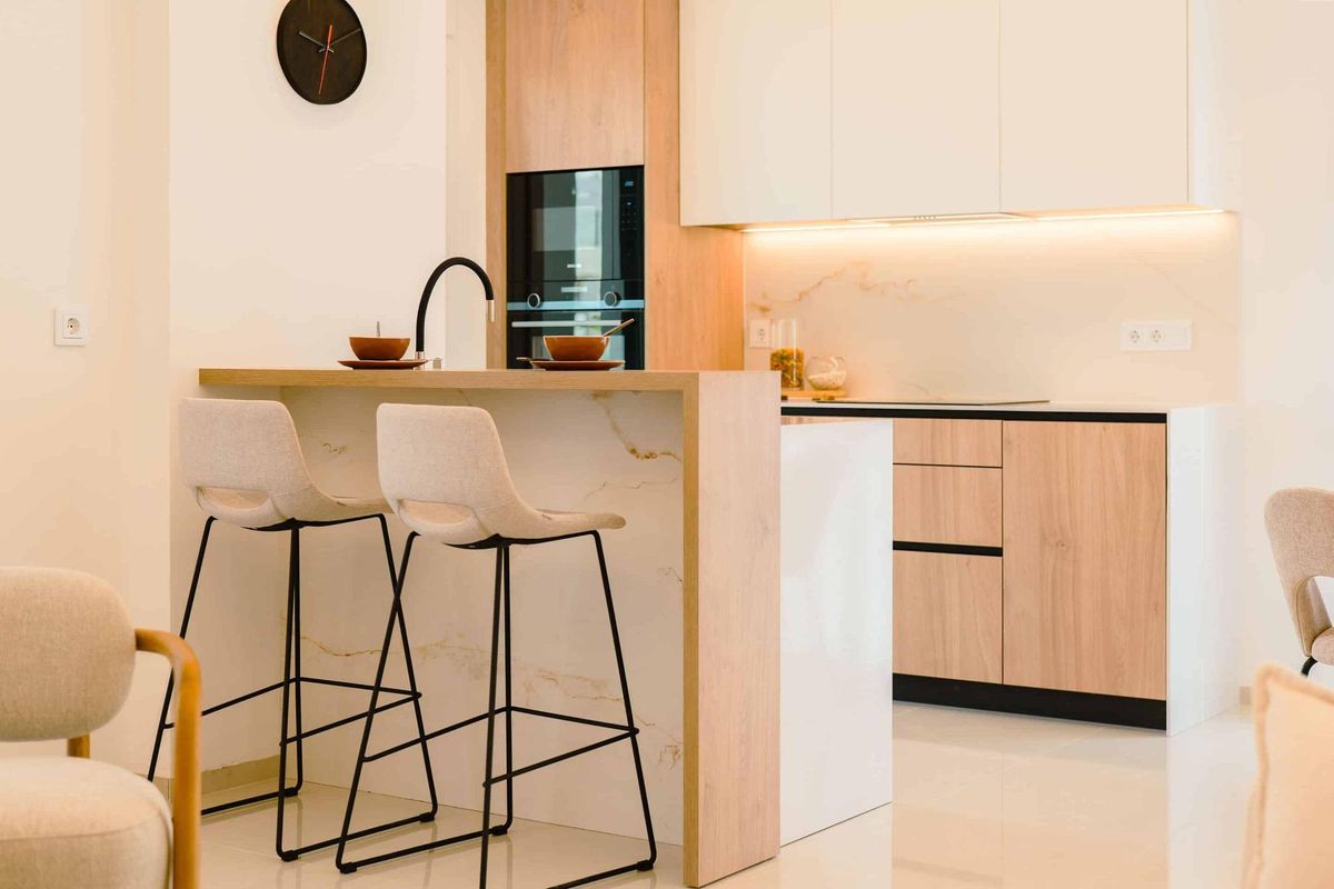 Contemporary keukeneiland met barkrukken, onderdeel van een strak ontwerp in het Rojales appartement.