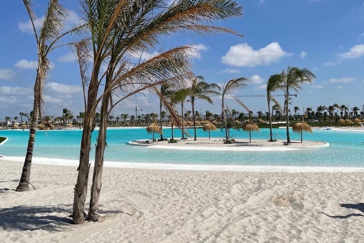 Mooie zandstrand met palmbomen bij het zwembad in Los Alcazares, een perfecte plek om te zonnen.