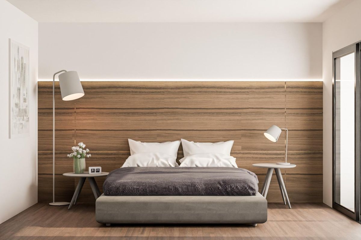 Serene bedroom with a wooden accent wall and comfortable bedding, located in a 3-bed villa in Pinoso, Costa Blanca.