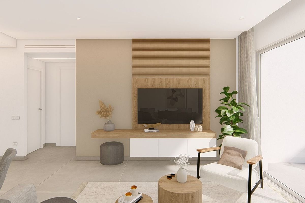 Modern living room in a 3-bed apartment, features a TV unit and a view of the terrace in Guardamar del Segura.