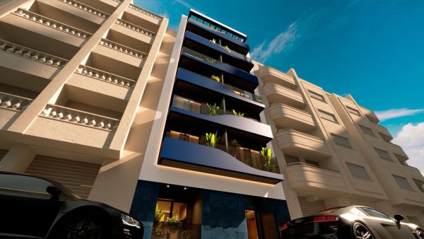 Modern 2-bed apartment building in Torrevieja, featuring stylish balconies and greenery.