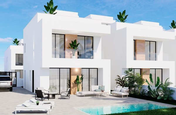 Buitenzicht op een moderne 3-slaapkamer townhouse in Orihuela Costa, met een zwembad en een groene tuin.