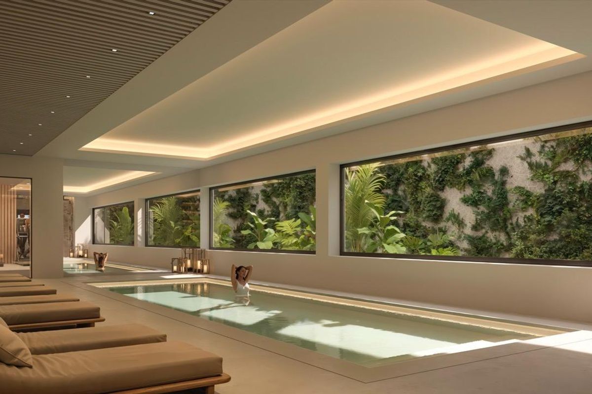 Ruimtelijk binnenzwembad omringd door groen voor ontspanning in San Pedro De Alcantara, Costa del Sol, Spanje.