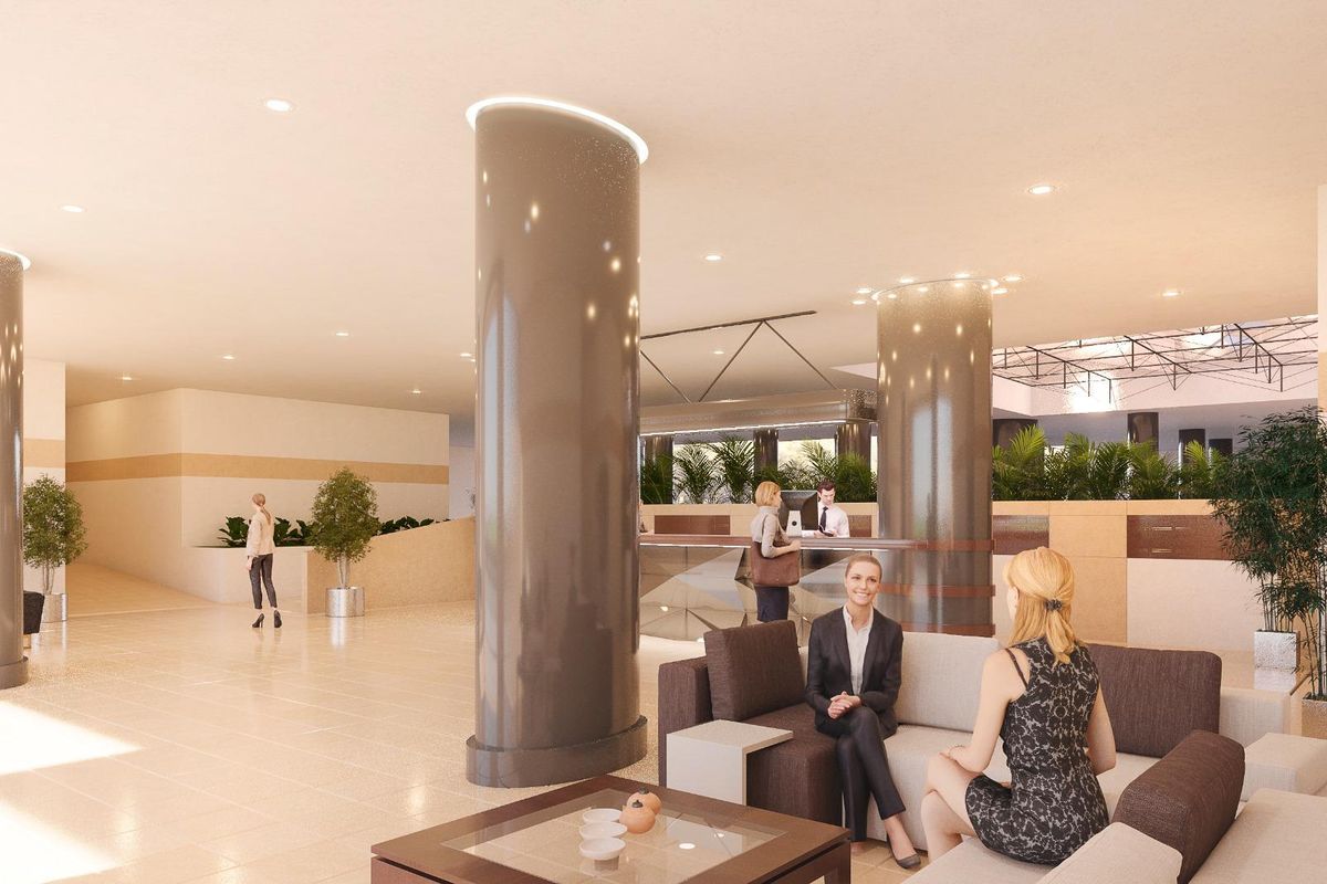 Moderne lobby van het appartementencomplex in Marbella met zitruimtes en incheckbalies.