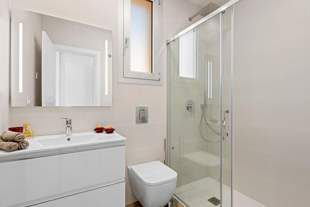 Stijlvolle badkamer met glazen douche en moderne armaturen in een penthouse in Orihuela Costa.