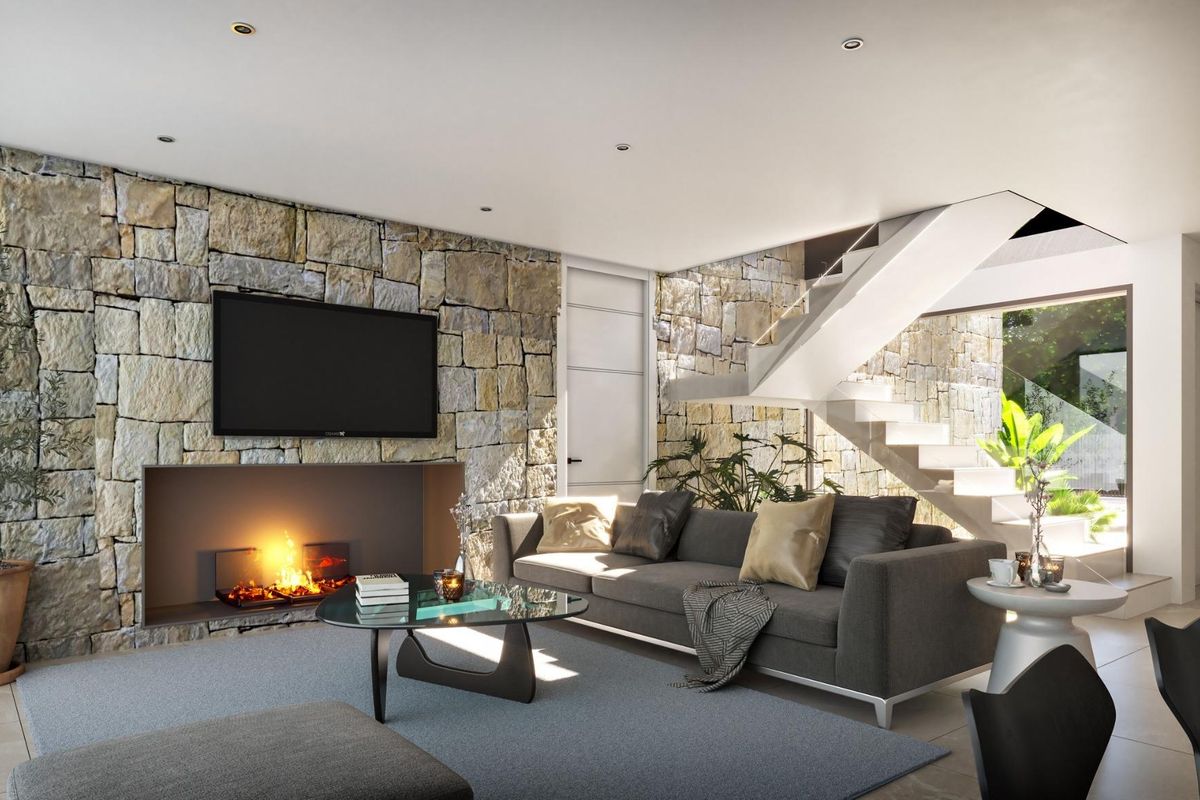 Gezellige woonkamer met stenen muur, open haard en modern design in Cuevas Del Almanzora, Costa de Almeria.