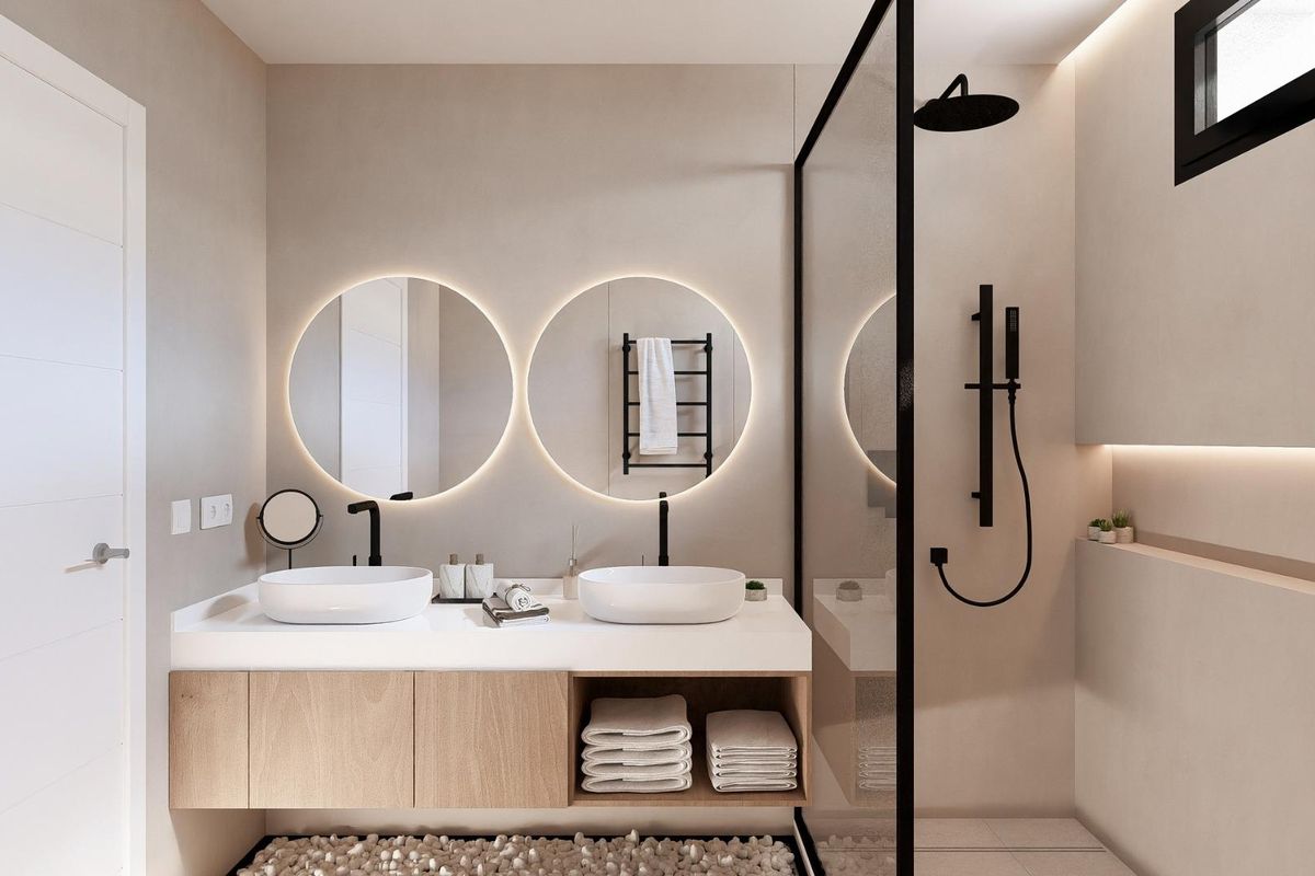 Moderne badkamer in een 3-slaapkamer villa met stijlvolle ronde spiegels en een ruime douche in Baños y Mendigo.