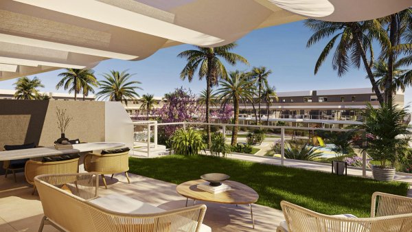 Spacious terrace with seating, lush gardens, and palm trees in Monforte del Cid, Costa Blanca South.