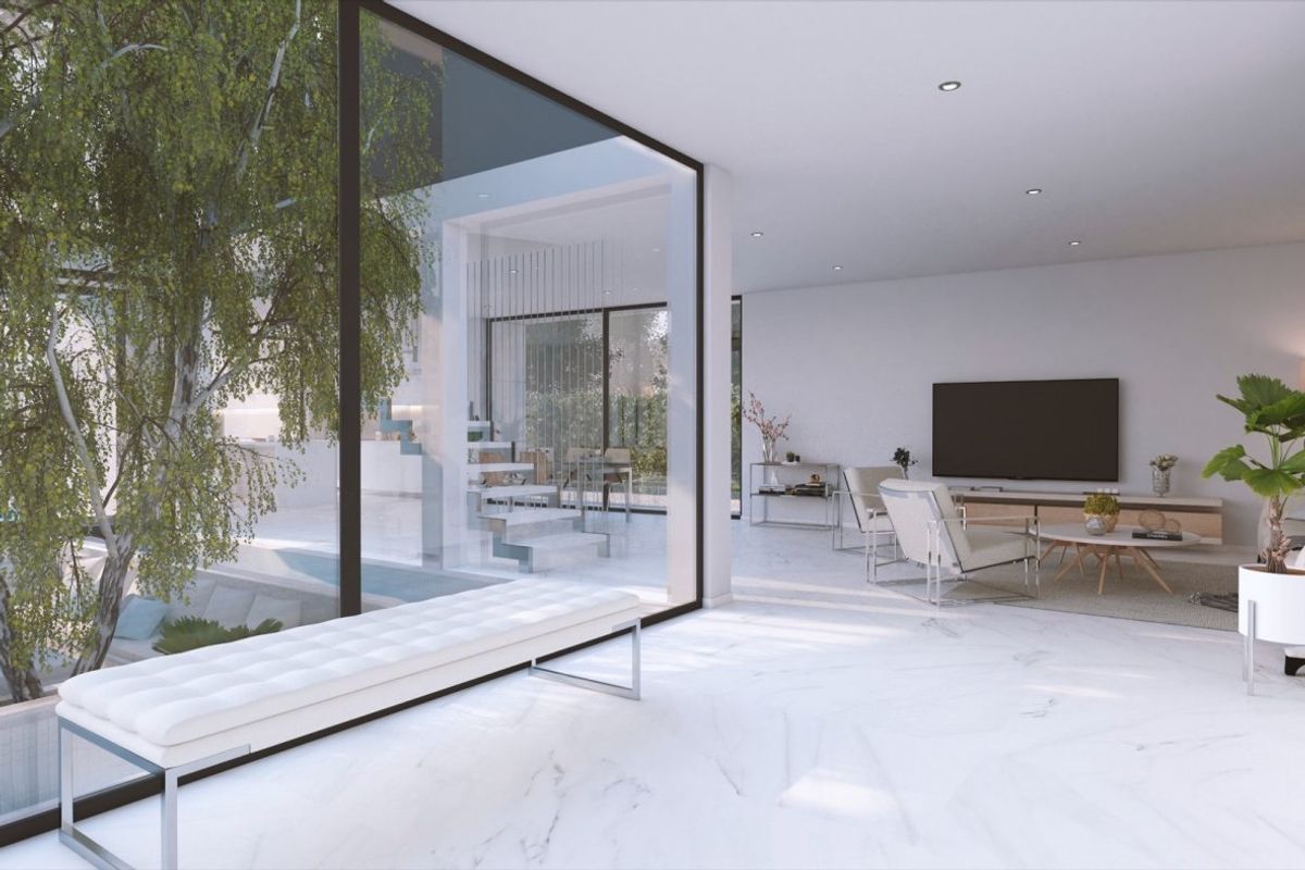 Stylish interior design featuring seating and a TV, brightened by natural light in Baños y Mendigo villa.