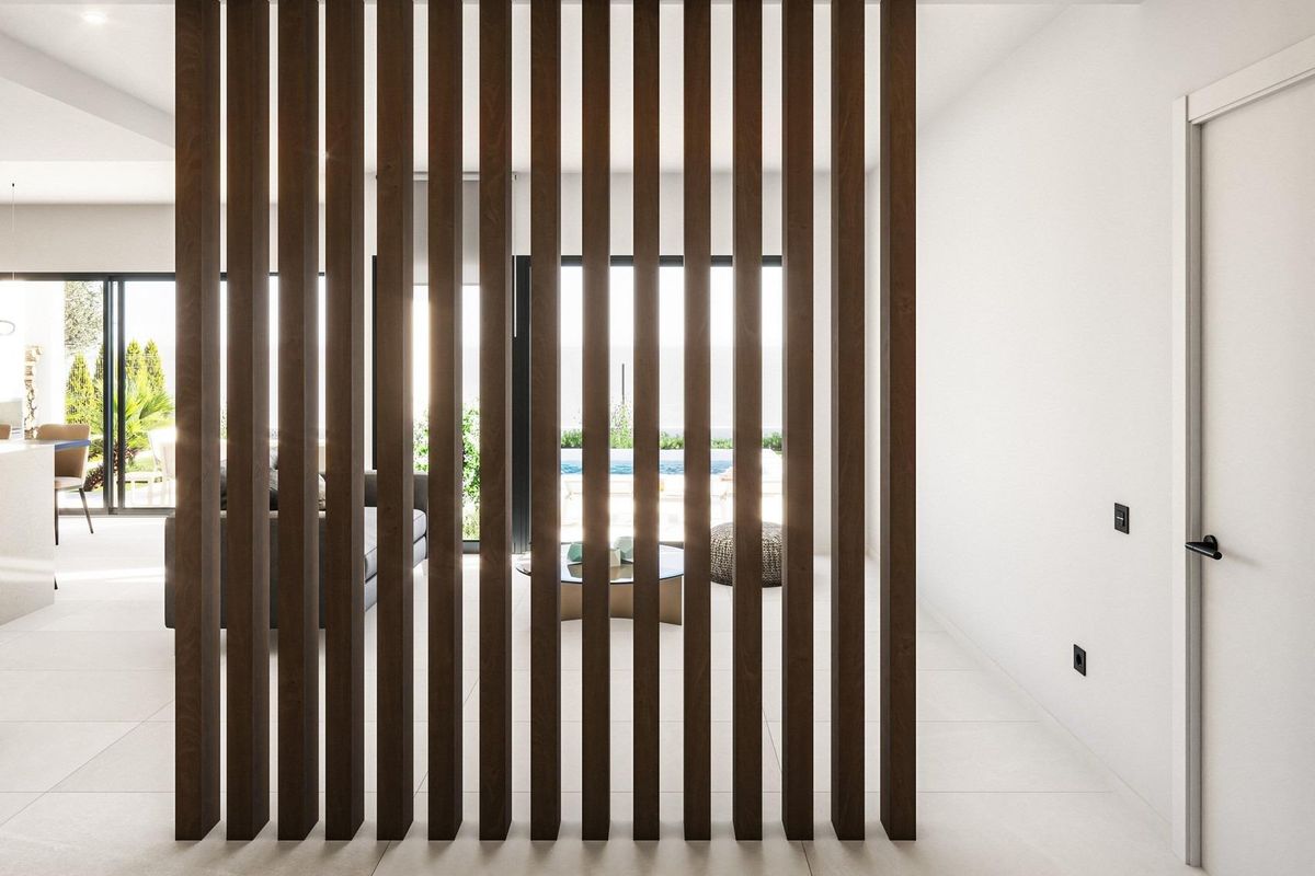 Decoratieve houten scheidingswand in een moderne villa in Los Alcazares, die interieurruimtes scheidt.