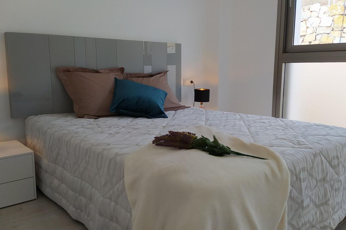 Gezellige slaapkamer in een moderne villa, met stijlvolle inrichting en natuurlijk licht in Orihuela Costa.