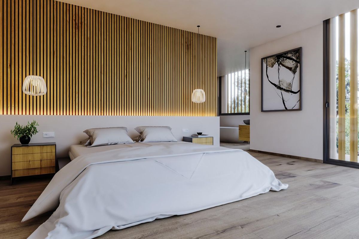 Elegante slaapkamer in villa in Alfas del Pi, met warme houten accenten en stijlvol ontwerp.