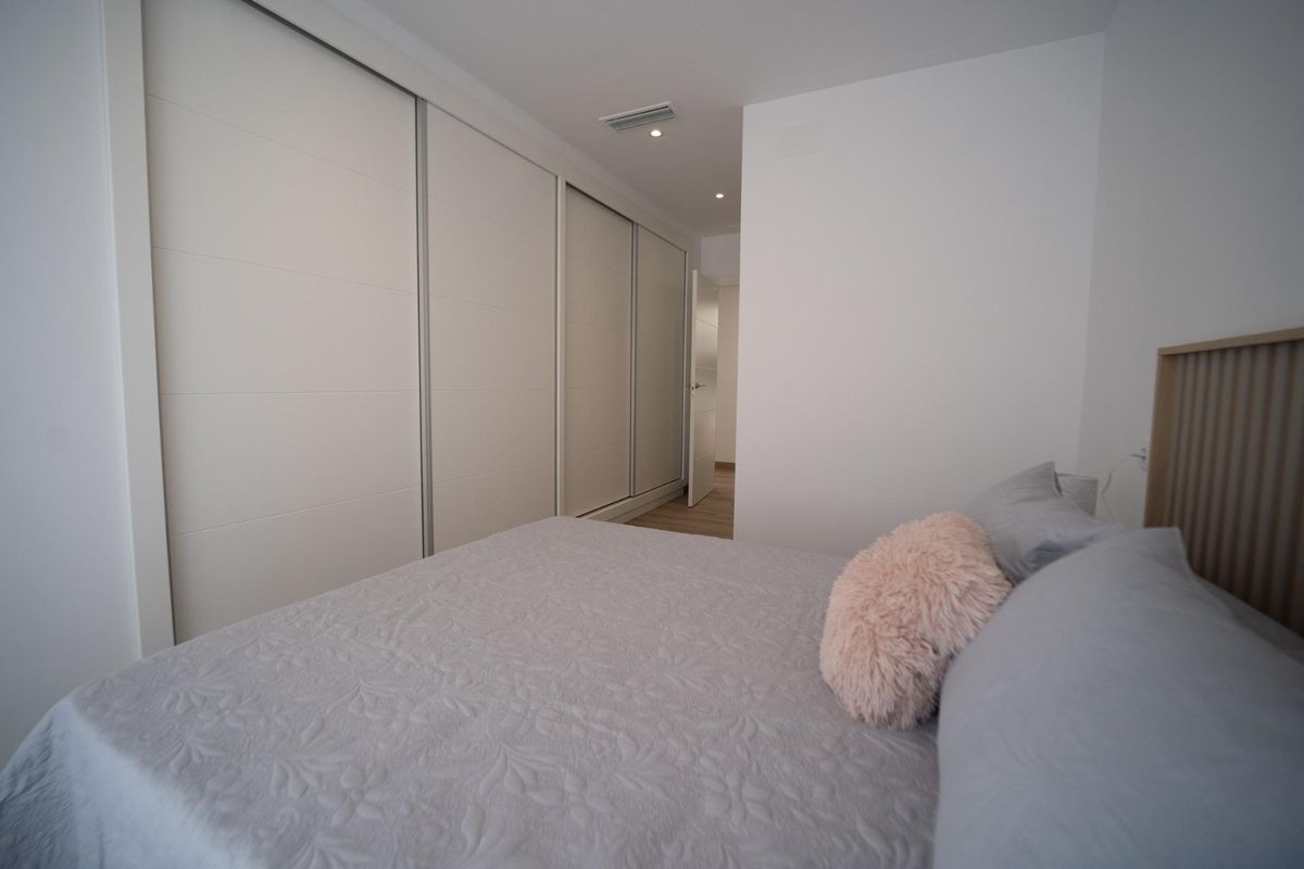 Interior shot of a bedroom with double bed and wardrobe in a 3-bed townhouse in Costa Calida. Modern style.