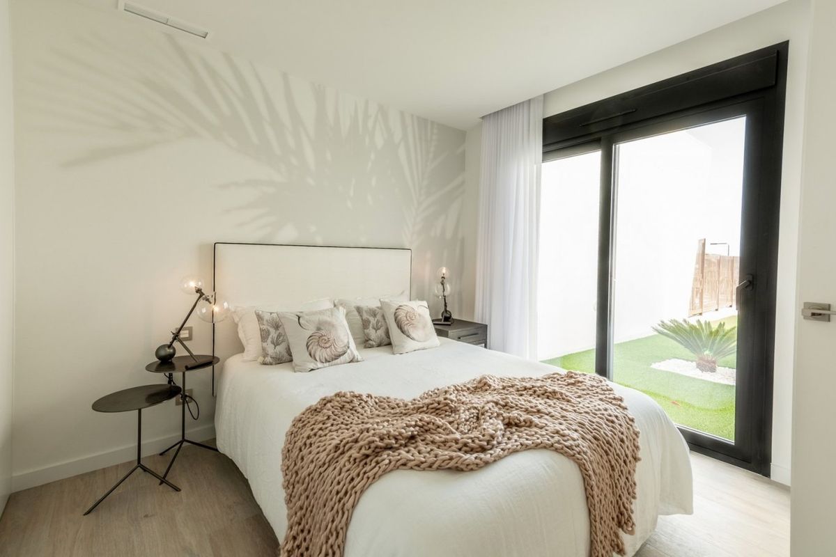 Light bedroom in a 4-bed villa in Finestrat, Costa Blanca, with large window overlooking the garden. Comfortable and modern.