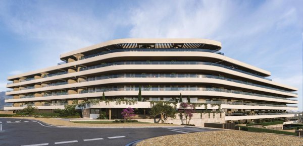 Buitenzicht op een modern appartementencomplex in Estepona, met strakke architectuur en groen.