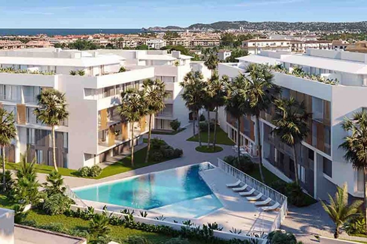 Buitenkant van een modern penthousecomplex met een zwembad in Jávea, Costa Blanca. Omgeven door palmbomen.