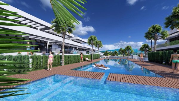 Poolgebied met palmbomen en zonaanbidders in een modern complex, Algorfa, Costa Blanca Zuid, Spanje.