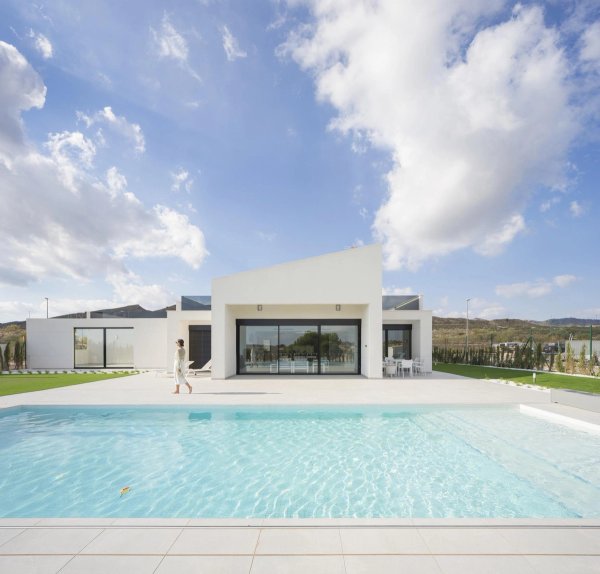 Modern 4-bed villa in Baños y Mendigo, showcasing stunning pool and exterior under a blue sky.