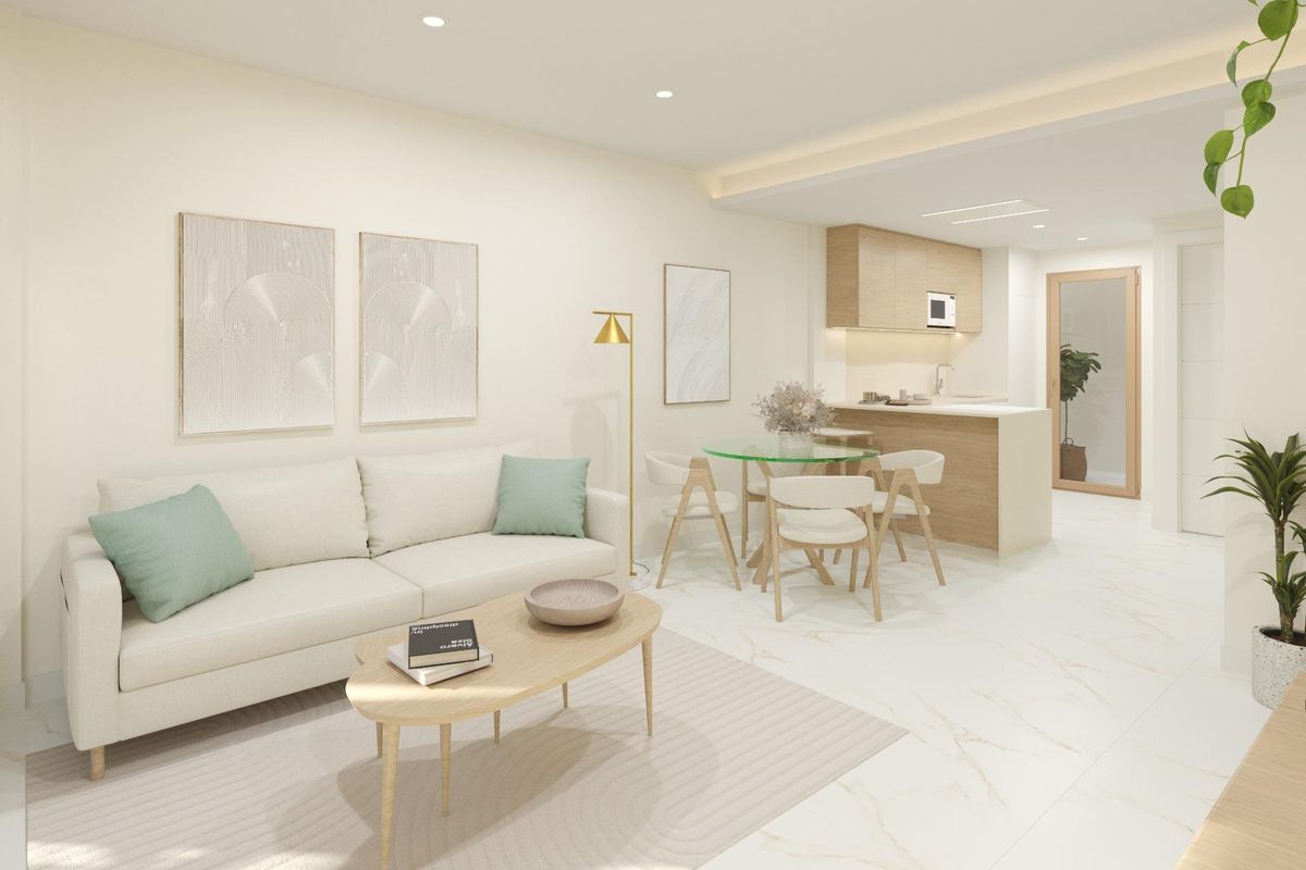Interior view of a modern townhouse in Dolores, Spain, showcasing the open-plan living and dining area with a glimpse of the kitchen.