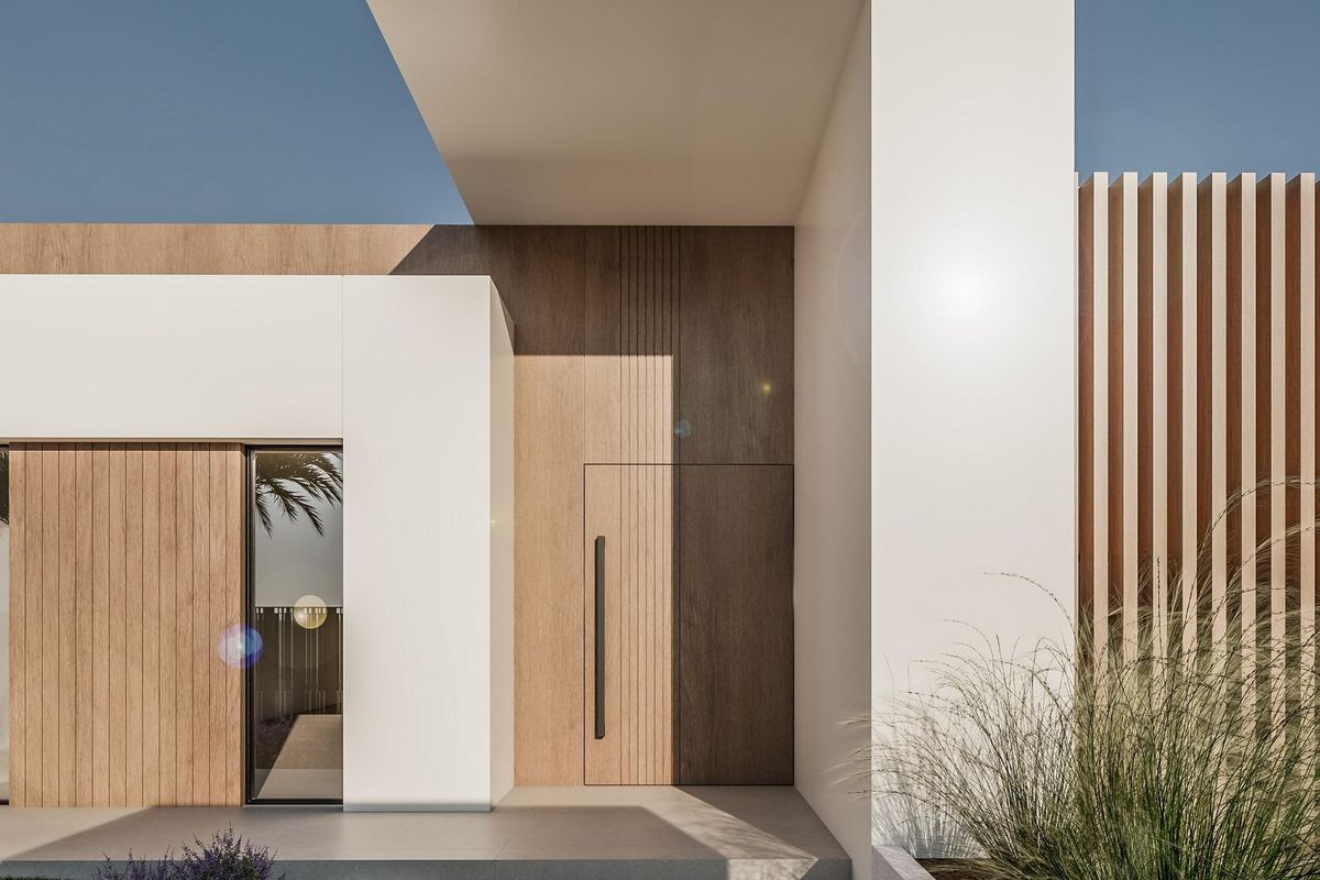 Welcoming entrance of a modern townhouse in El Campello, Costa Blanca, with sleek wood and glass design.