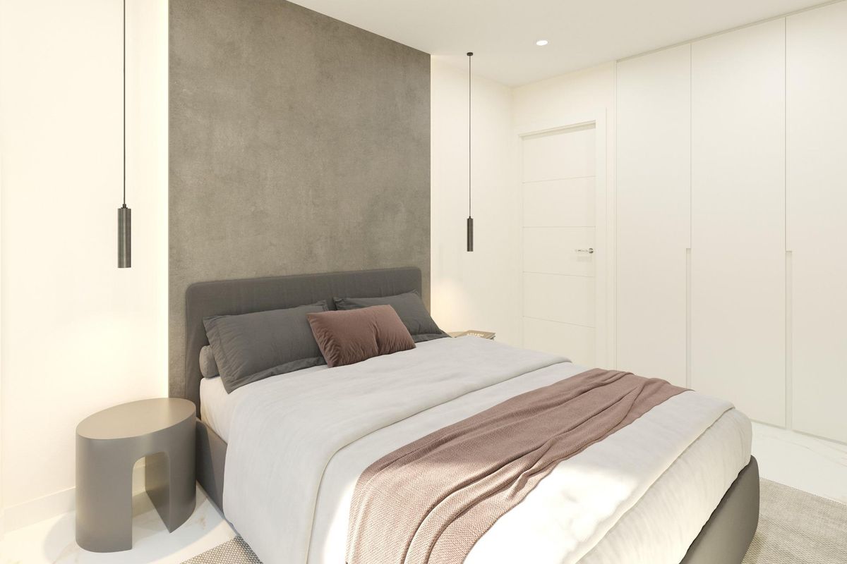 Modern bedroom interior in a 3-bed townhouse in Dolores, Costa Blanca South. Features double bed with grey headboard and modern lighting.