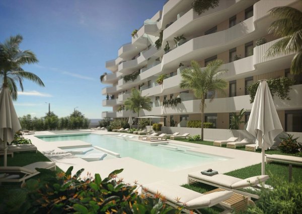 Zonnig zwembad met ligbedden bij een nieuw appartementencomplex in Mijas, Costa del Sol.