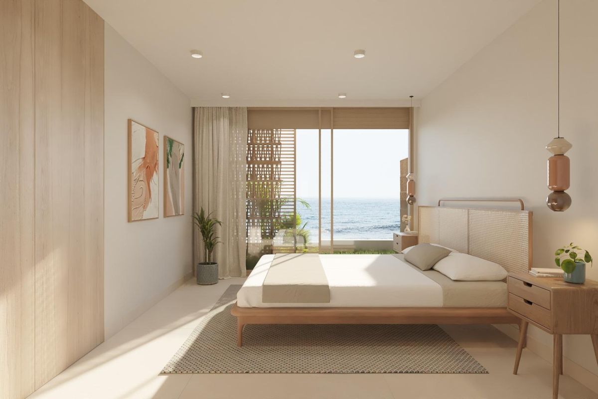 Lichtgevulde slaapkamer in een herenhuis in Cuevas Del Almanzora met uitzicht op zee en minimalistische decoratie.