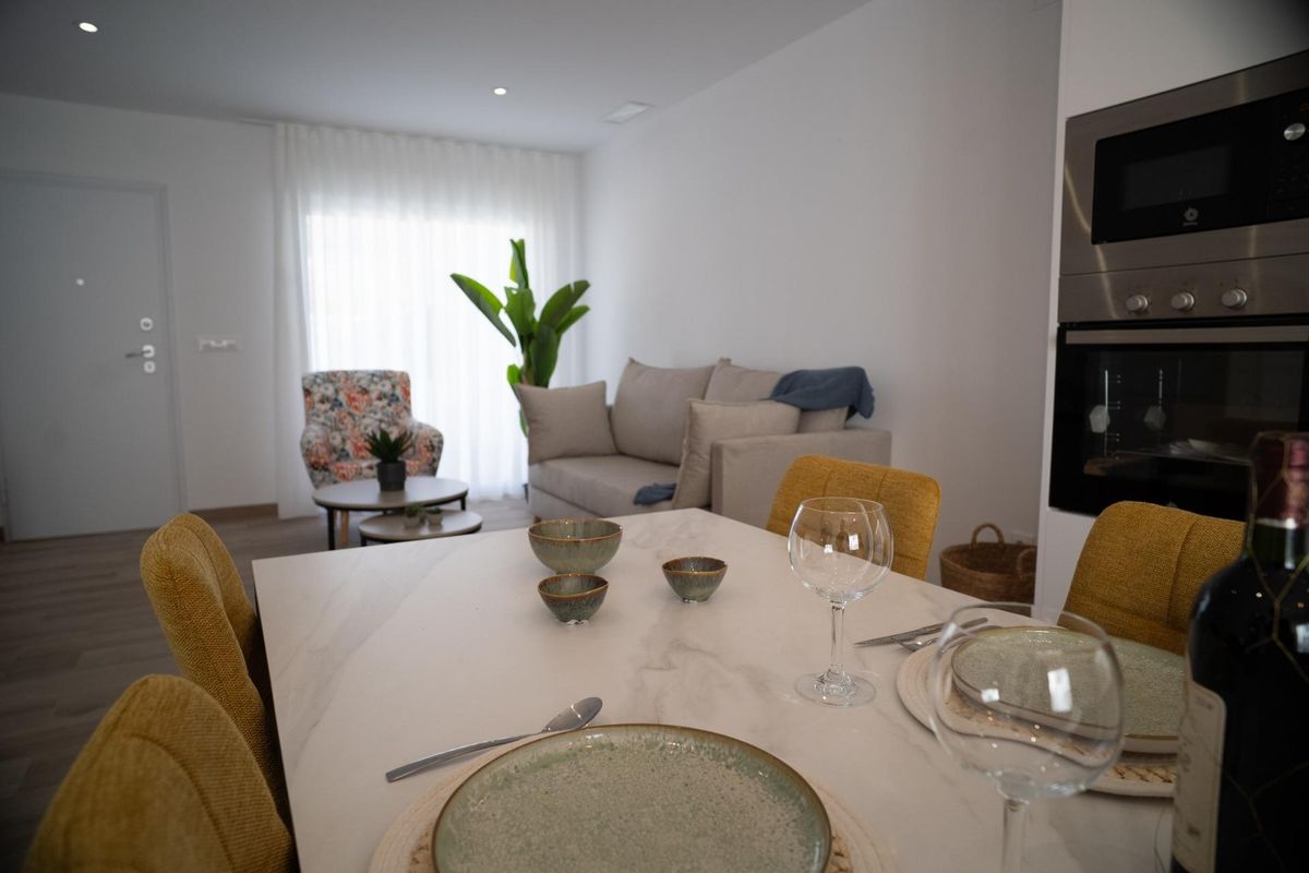 Open plan kitchen, dining, and living area in a 3-bed townhouse in San Javier, Costa Calida. Modern interior.